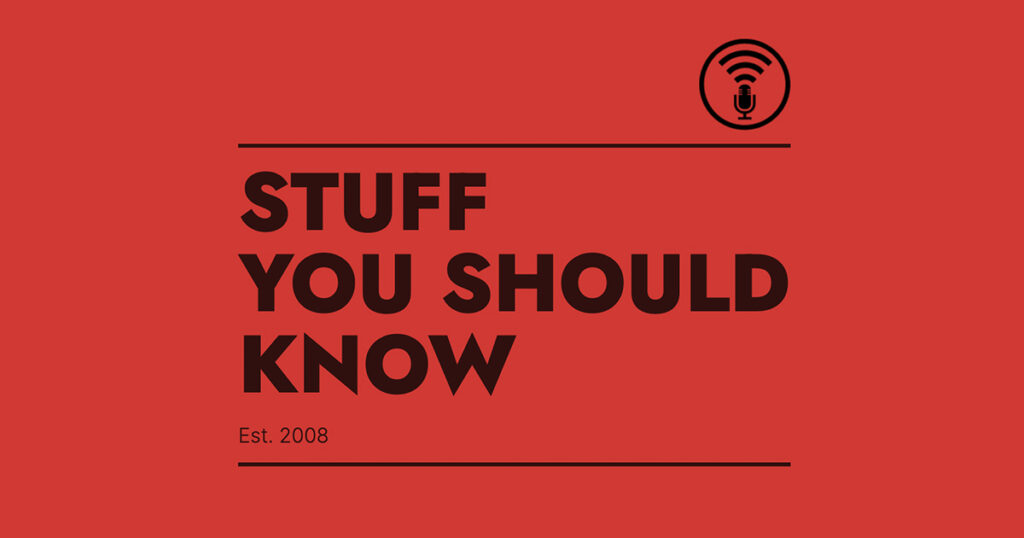 Red background with bold black text reading “Stuff You Should Know” and a small microphone icon above the title.